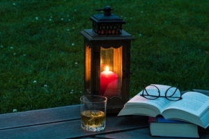 lantern on bench with book and glasses